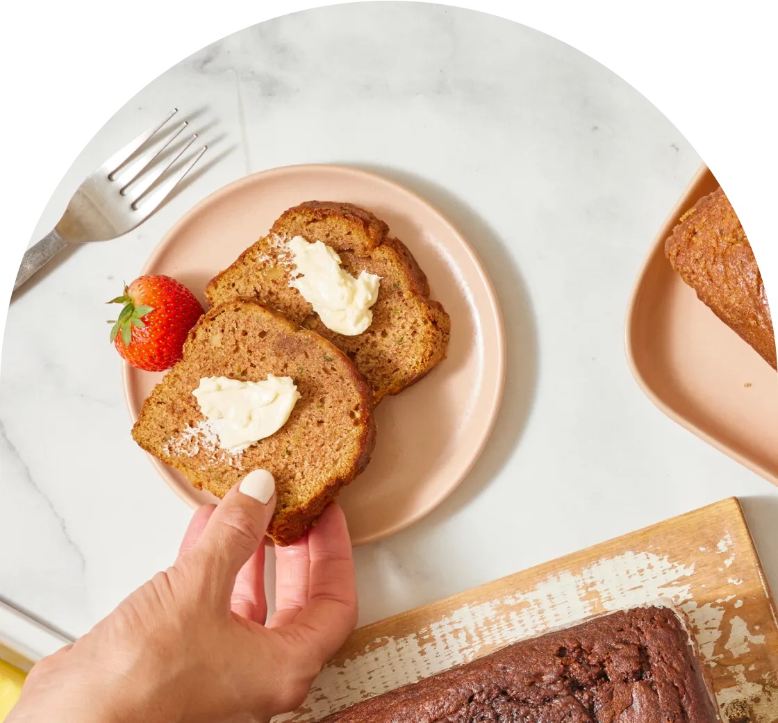 Hand grabbing slice of Zucchini bread 