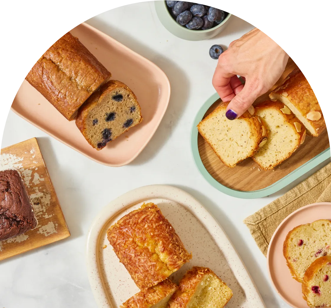 Hand reaching out for Almond Poppyseed bread on table 